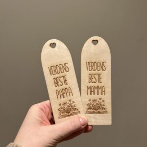 Personlig bokmerke med teksten “Verdens beste …”, lasergravert bok og blomster, hjerteformet hull på toppen, gravert blomst på baksiden, perfekt gave til mamma, pappa eller andre nære personer.
