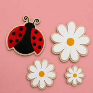 Veggdekorasjon til barnerommet laget i bjørkfiner og akryl. Her ser du en marihøne og tre blomster på en rosa bakgrunn.